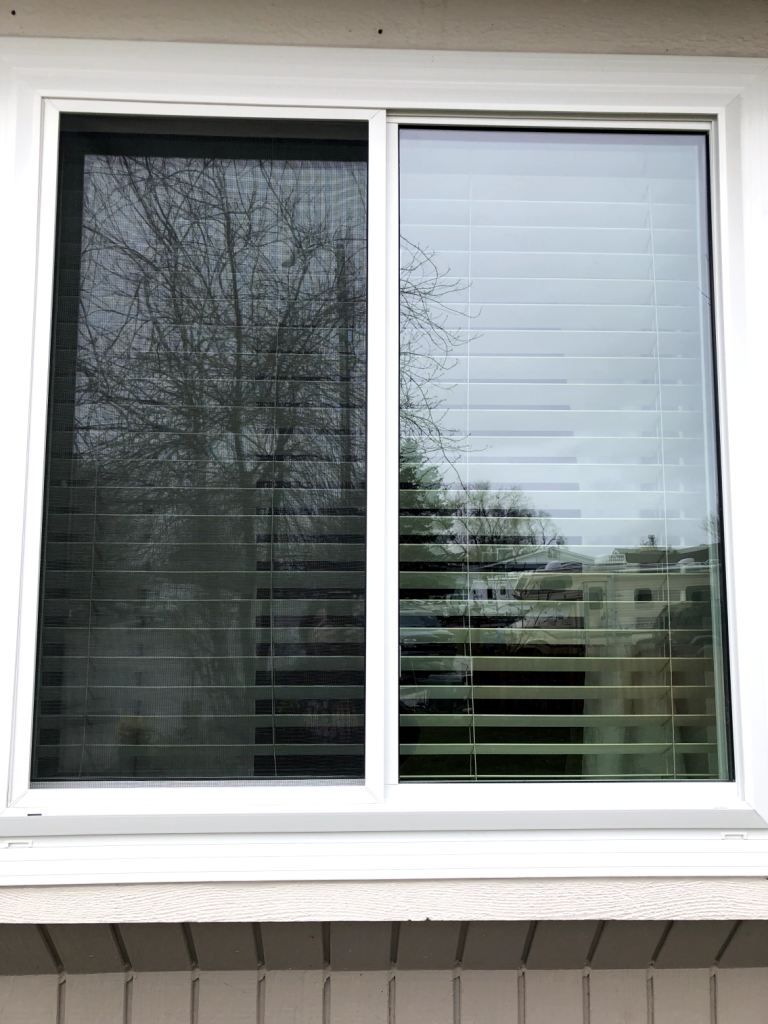 Window with blinds and reflections