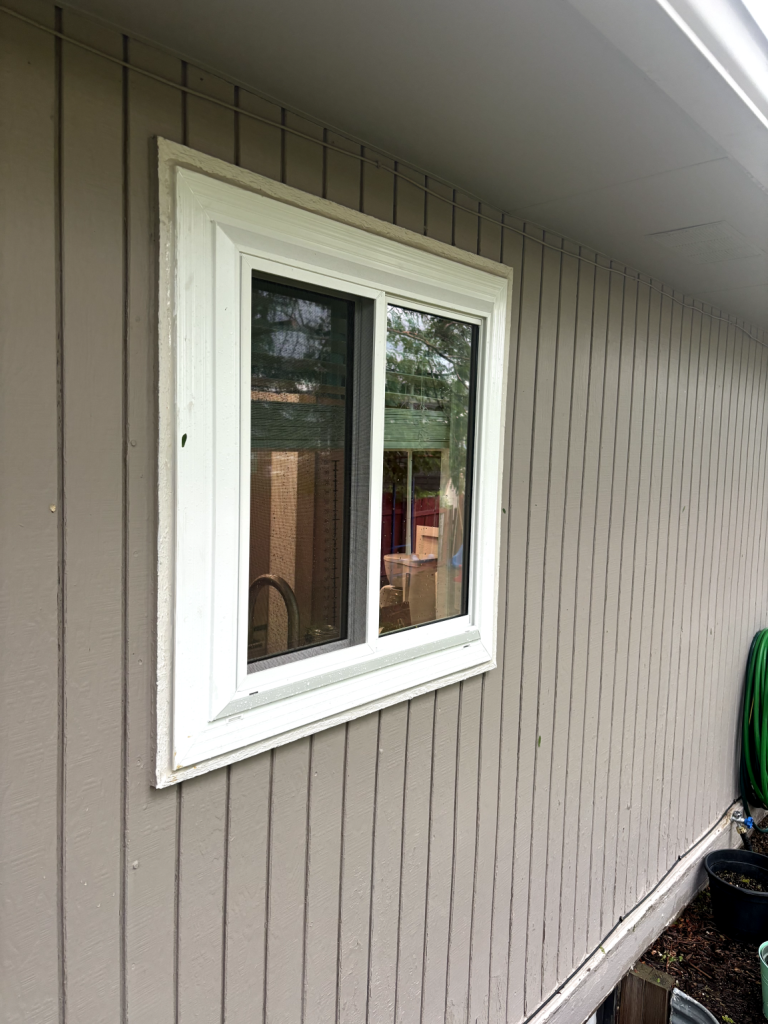 White window on gray wooden wall