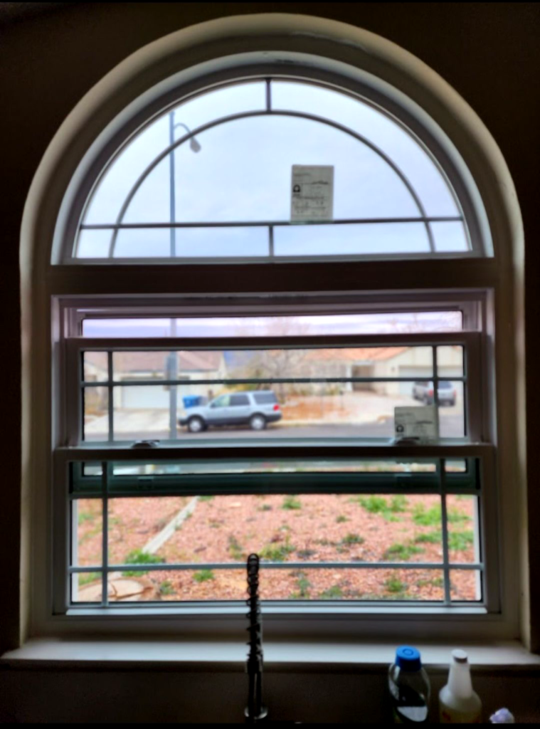 Arched window with cloudy view outside