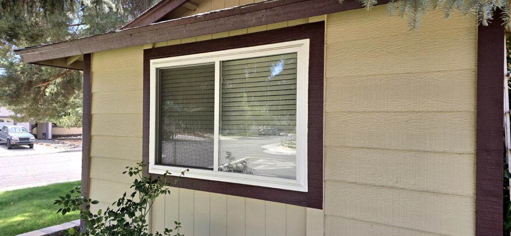House exterior with window and greenery