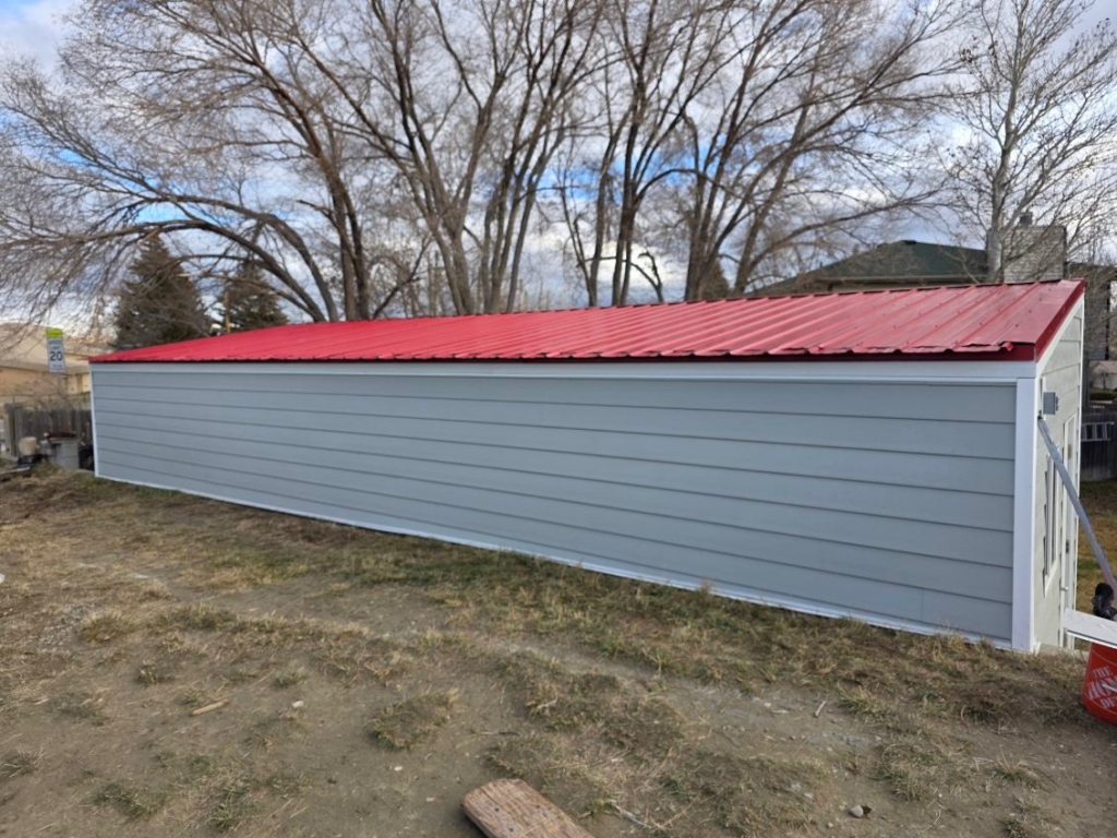 Long gray building with red roof