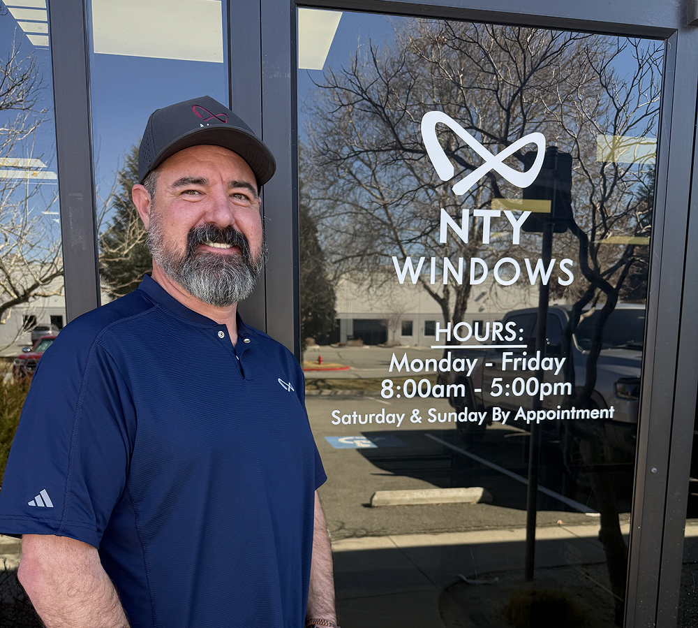 Man standing by business window.