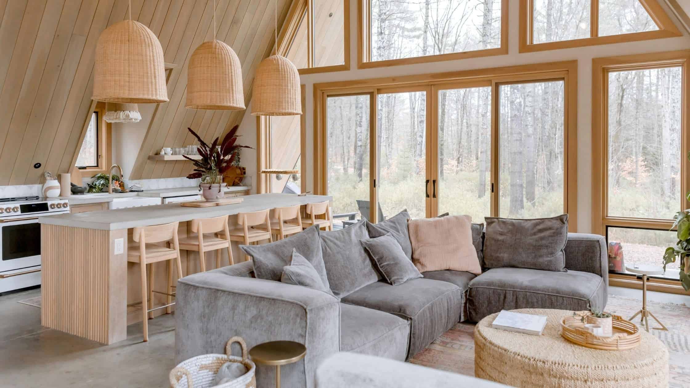 Bright living room with large NTY Windows showcasing outdoor scenery.