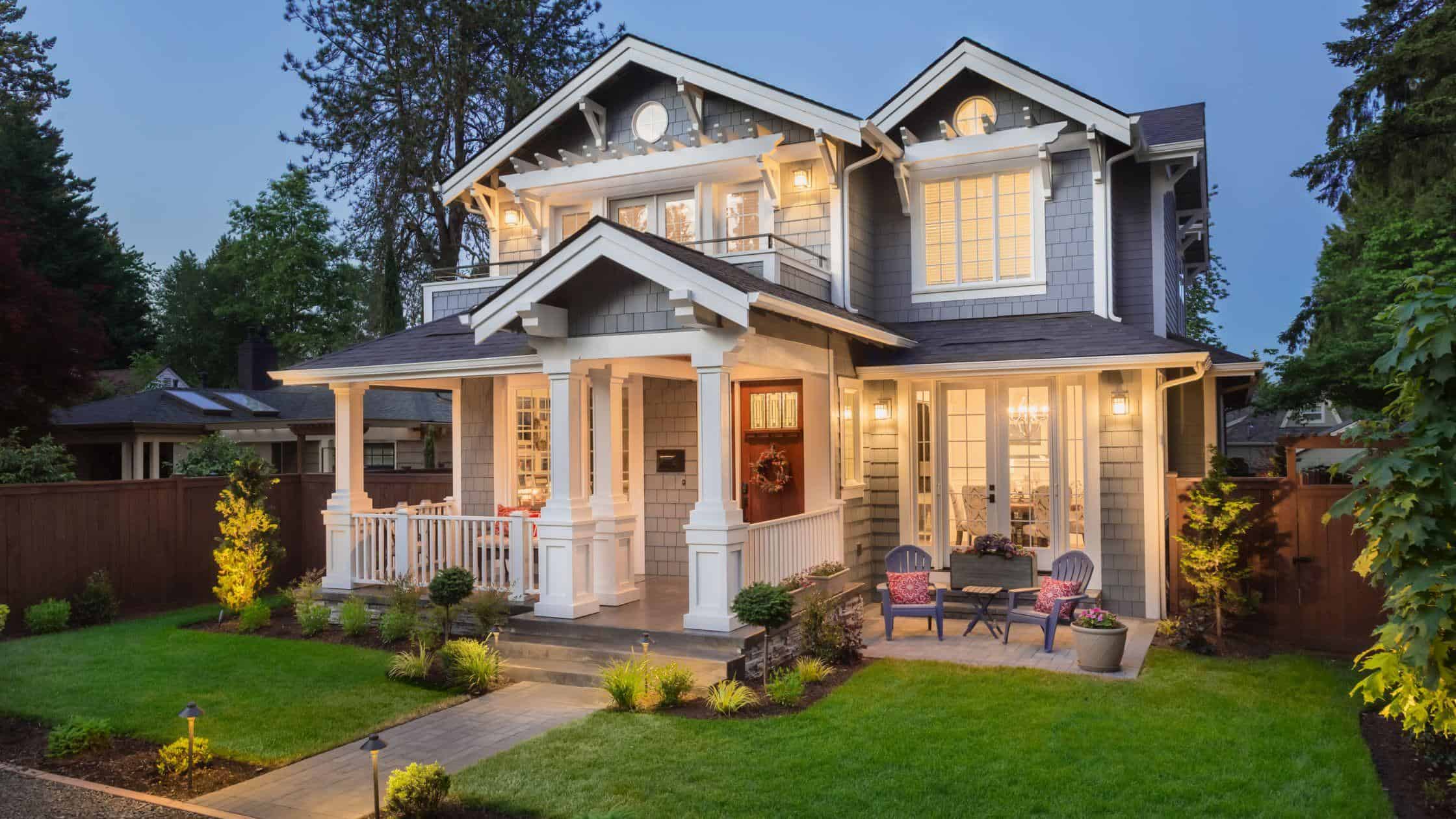 Beautiful modern craftsman-style house with inviting porch and well-maintained yard.